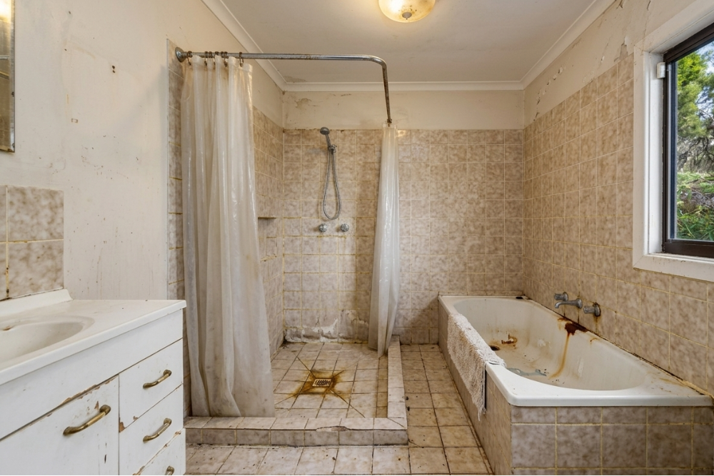 Old, corroded bathroom plumbing pipes in Jumeirah villa before replacement